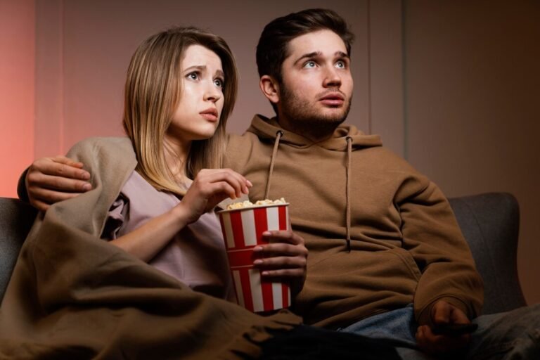 couple-watching-tv-eating-popcorn_23-2148868649